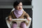 Baby Kiara sitting in a highchair wearing a KIDLY Label bib, sweatshirt and leggings