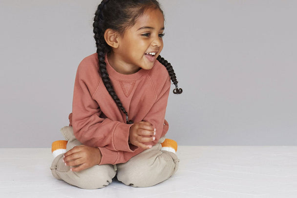 Bronte laughs, wearing our Brushback Sweatshirt & Loopback Jogger